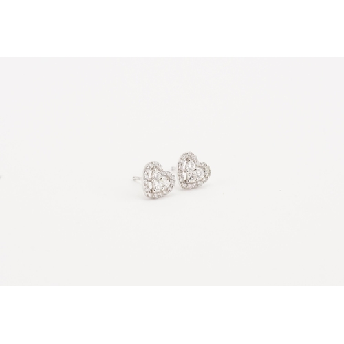 74 - A pair of 18ct white gold diamond set earrings, in the heart design. The heart is created by two bri... 