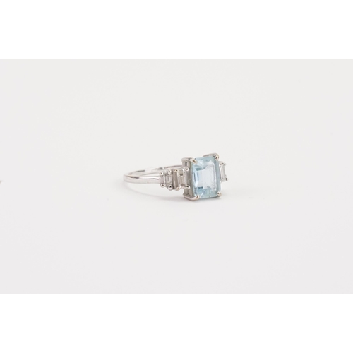 75 - A 18ct white gold Aquamarine and diamond set ring, set with an emerald cut aquamarine 8.9mm x 6.8mm.... 