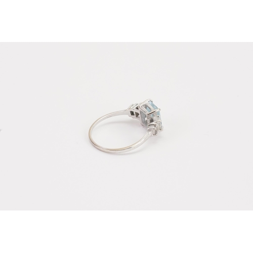 75 - A 18ct white gold Aquamarine and diamond set ring, set with an emerald cut aquamarine 8.9mm x 6.8mm.... 