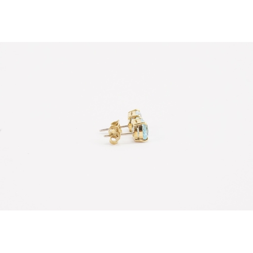 76 - A pair of 18ct yellow and white gold aquamarine earrings, in the oval form. Size approximately 9mm x... 