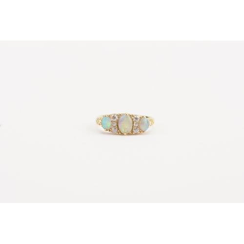 90 - A 18ct gold opal and diamond set ring. Set with three opals and six diamonds. Weight 4.2g. Size P. T... 