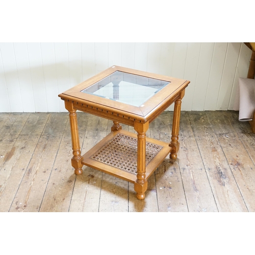 607 - A glass topped coffee table, with rattan base.