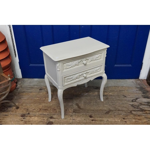 603 - A Cream painted Two Drawers Bedside Table. Measuring: 58cms across x 36cms deep x 66cms high.