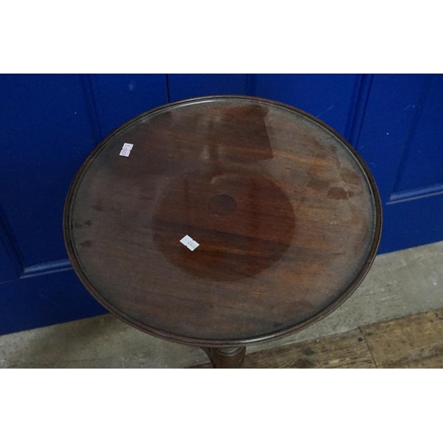 604 - A Mahogany Tripod Wine Table. Measuring: 38cms across x 72cms High.