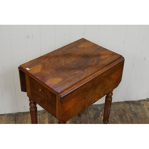 595 - A Victorian Walnut veneered Bedside Table with a drop door & resting on turned fluted legs. Measurin... 