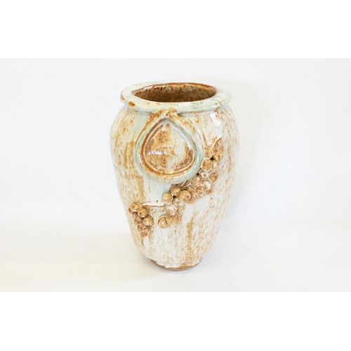 721 - A mottle glazed cylindrical vase with fruit decoration. Standing: 34cms.