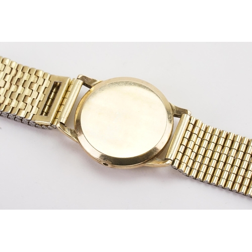 192 - A 9ct gold Zenith Watch in a Denison case, with a gold plated strap.