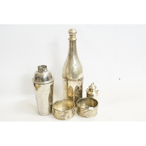 57 - A Silver Plated Cocktail Shaker designed as a Champagne Bottle, Two Coasters, a Milk Urn & a Liner.