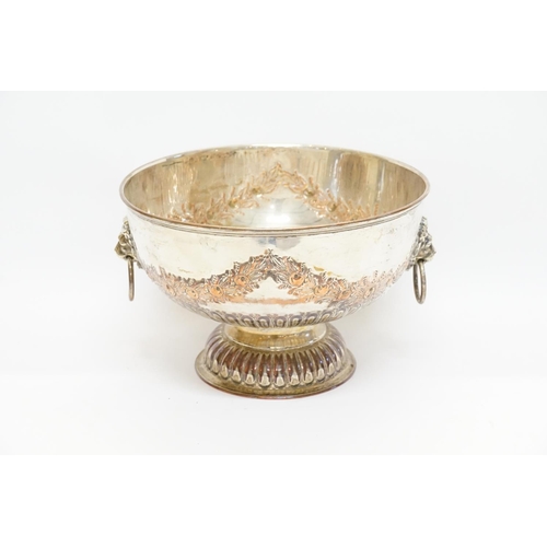 65 - A Silver on Copper hand chased Punch Bowl with Lion decorative Handles. Measuring: 26cms across x 17... 