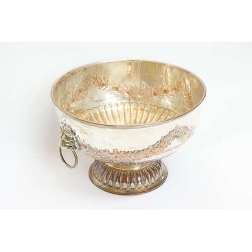 65 - A Silver on Copper hand chased Punch Bowl with Lion decorative Handles. Measuring: 26cms across x 17... 