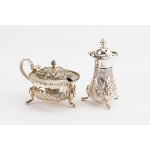 30 - A sterling silver floral embossed Indian mustard pot & silver pepper shaker.