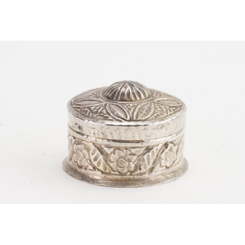 33 - An Indian circular embossed pill box, shield decorated. Weight: 28.4g