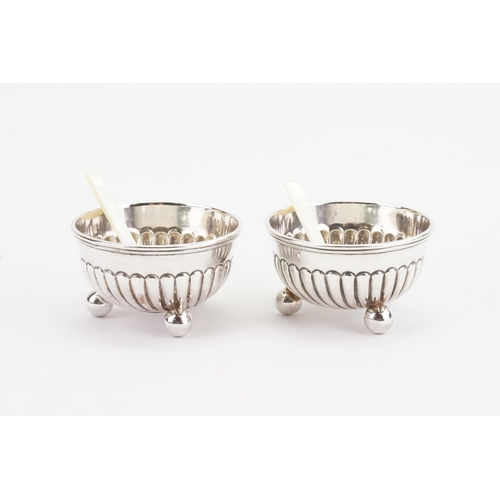 45 - A pair of 1894 John Round & Son Ltd silver condiment pots, with mother of pearl spoons. Weight 70g.