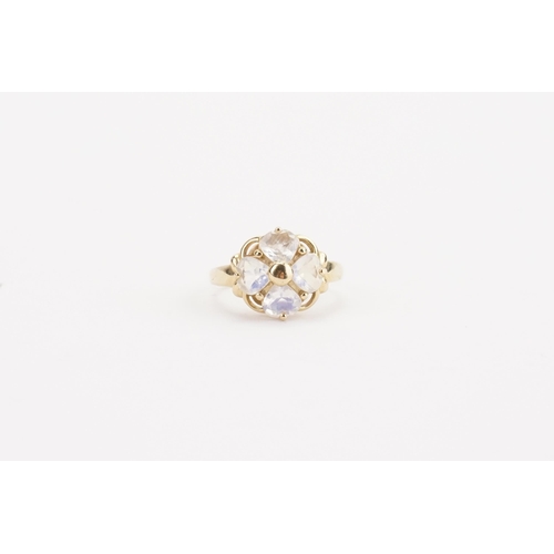 87 - A 9ct gold and moon stone set ring, in the floral design. Weight 4.2g. Size O.