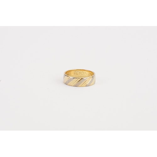 111 - A 18ct yellow and white gold ring. Size I. Weight 3.3g.