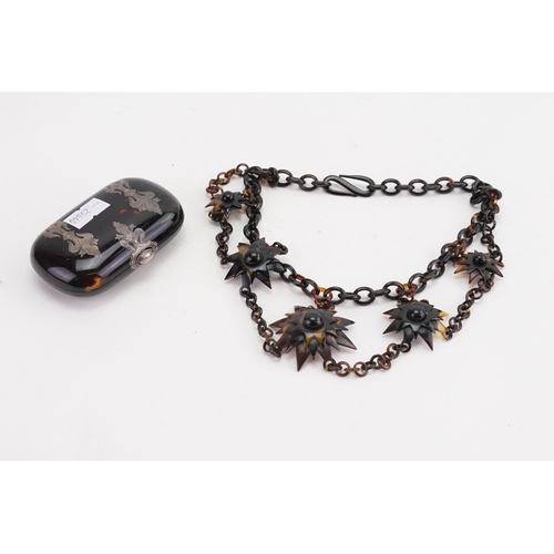 135 - A tortoise shell style necklace, along with a tortoise shell purse.