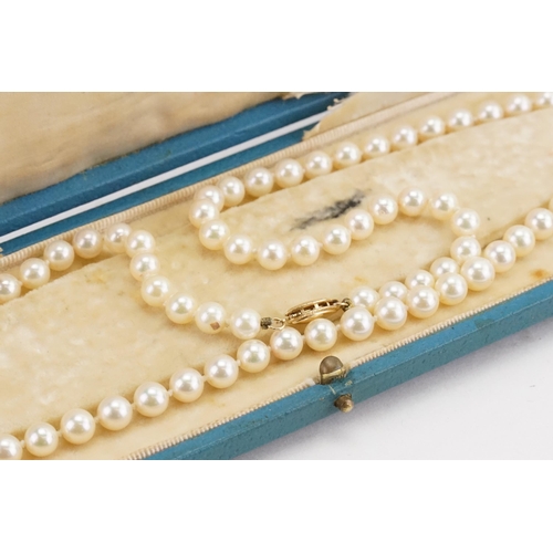 149 - A strand of pearls hung on a 14ct gold clasp, contained in case.