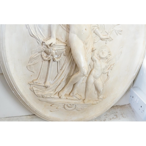 555 - A Plaster Plaque depicting a Semi-Nude Classical Maiden with a Cupid & resting her hand on an Incens... 