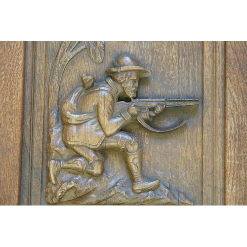 964 - A Late 19th Century Carved Oak Panel of a Huntsman along with one other of a Bird of Paradise.