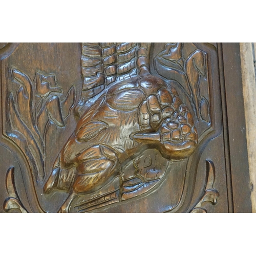 964 - A Late 19th Century Carved Oak Panel of a Huntsman along with one other of a Bird of Paradise.