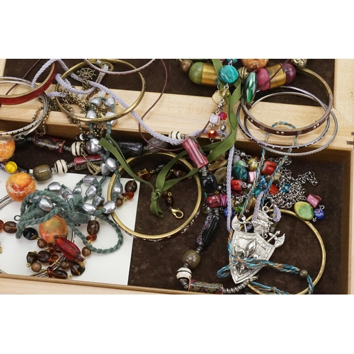 172 - A wooden box containing costume jewellery, to include bead necklaces, bangles etc.