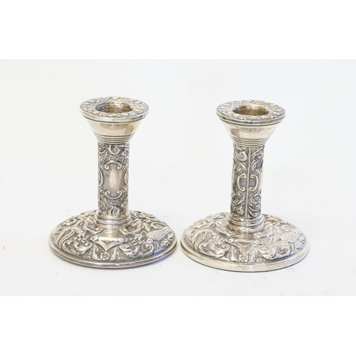 28 - A Pair of 1971 silver embossed candlestick holders. Hallmarked B. and C.