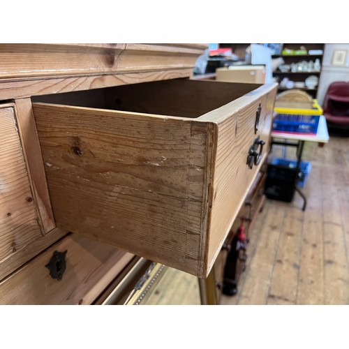 585 - A Pine Tallboy Chest fitted with graduated drawers, Brass Handles & resting on Bracket Feet. Measuri... 