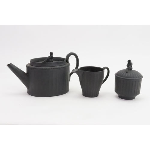 813 - A Wedgwood Adam's design Black Basalt Tea Pot, Sugar Bowl & cover & Cream decorated with female fini... 