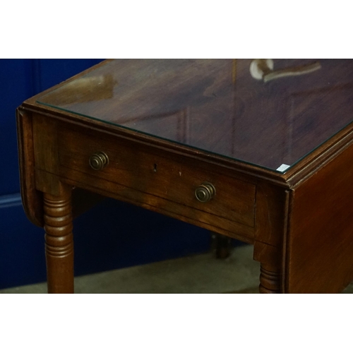 513 - A Georgian Mahogany Drop Flap Pembroke Table fitted with a single drawer, resting on turned legs & B... 