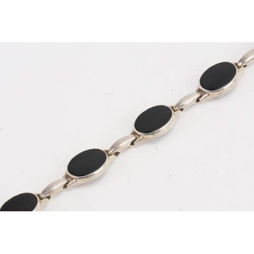 183 - A Silver and Onyx Set Bracelet. Weight: 21 grams.