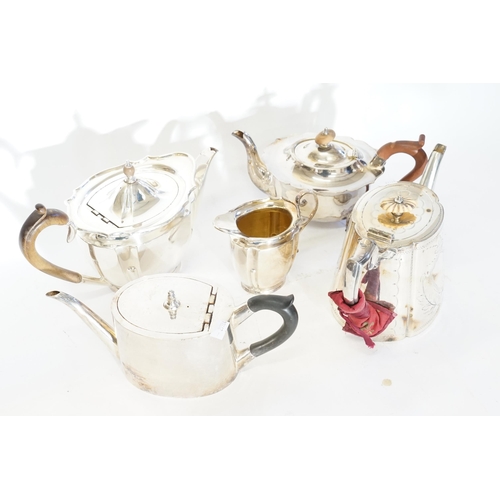 134 - Four various Silver Plated Tea Pots along with a Silver Plated Cream Jug.