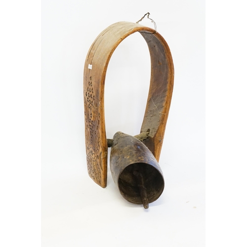 867 - An Antique Cow Bell with a carved Friesian Steamed Wood Collar with a coloured & patinated Bell.