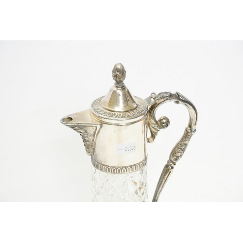 128 - A Claret Jug in the Classical design with a Silver Plated mount marked G and A Hand.