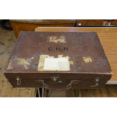 693 - An Army & Navy Brass mounted Suitcase with Stickers in Canvas with Leather Stitched Corners on a Woo... 