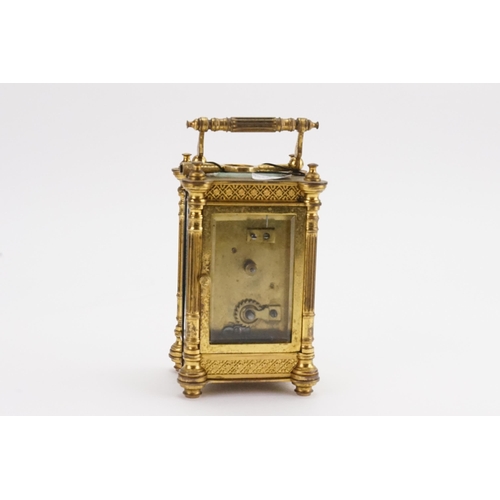 230 - A Brass Cased Carriage Clock with a Floral Stamped Border, Column Sides, Enamelled Chaptering & Key.