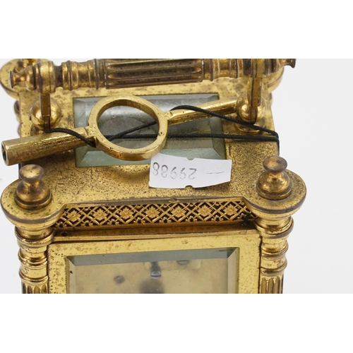 230 - A Brass Cased Carriage Clock with a Floral Stamped Border, Column Sides, Enamelled Chaptering & Key.