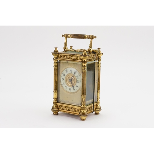 230 - A Brass Cased Carriage Clock with a Floral Stamped Border, Column Sides, Enamelled Chaptering & Key.