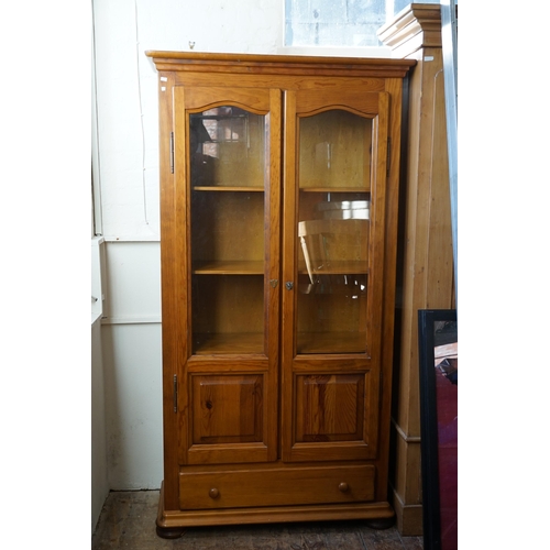 522 - A French pitch pine two door book case, fitted with shelves. Measuring  100cm x 186cm H x 41cm D.