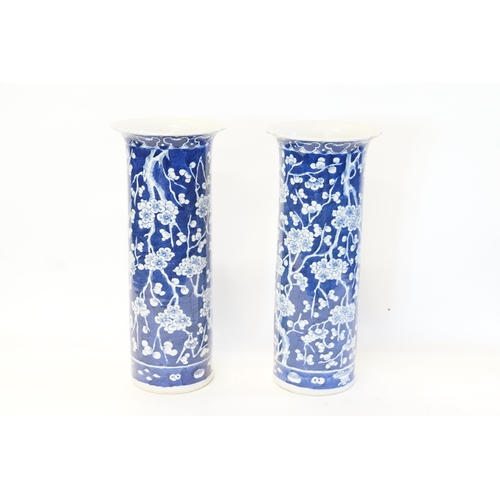 635 - A pair of Chinese blue and white trumpet shaped vases, decorated with prunus leaf. Measuring 36cm.