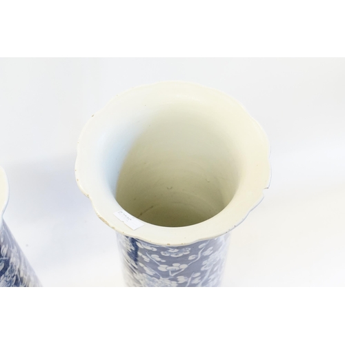 635 - A pair of Chinese blue and white trumpet shaped vases, decorated with prunus leaf. Measuring 36cm.