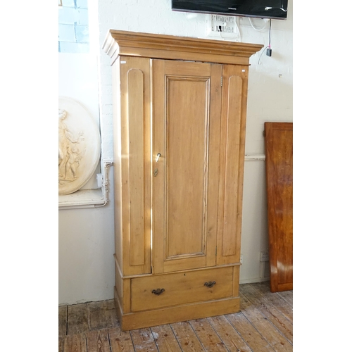 579 - A Pine Single Door Wardrobe with Drawer. Measuring: 106cms across x 203cms high x 51cms deep.