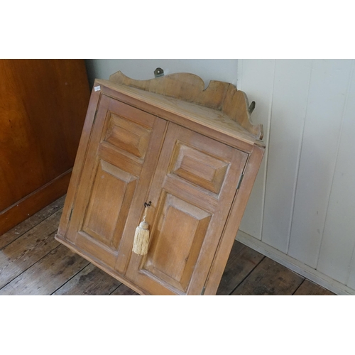 581 - A Panelled Pine Corner Cabinet. Measuring: 55cms across x 67cms high x 39cms deep.