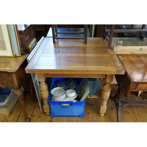 602 - A 1920s Oak Drawer Leaf Table resting on turned legs. Measuring: 91cms across x 80cms high.