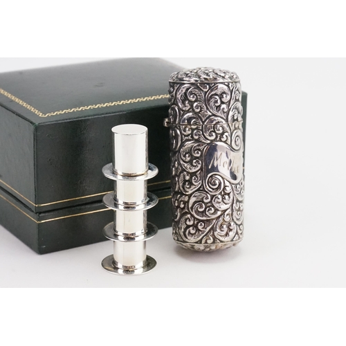 93 - A Silver coloured embossed Perfume Bottle Case containing a Silver Coloured Sewing Set & a Cigarette... 