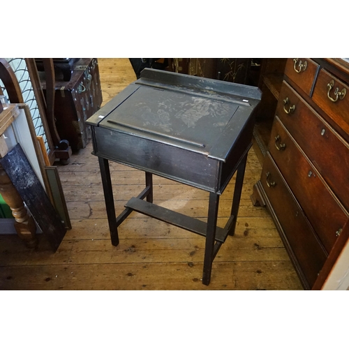 596 - An Antique Oak Lift-Top Child's Desk resting on square legs. Measuring: 60cms across x 44cms deep x ... 