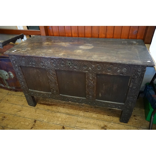 550 - An Antique Jacobean design Three Panelled Oak Coffer with chip carved decoration fitted with a Candl... 