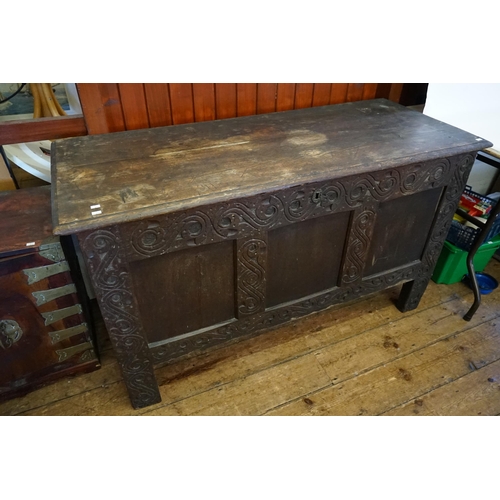 550 - An Antique Jacobean design Three Panelled Oak Coffer with chip carved decoration fitted with a Candl... 