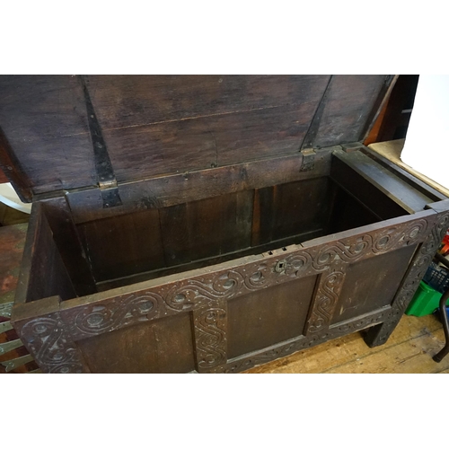 550 - An Antique Jacobean design Three Panelled Oak Coffer with chip carved decoration fitted with a Candl... 