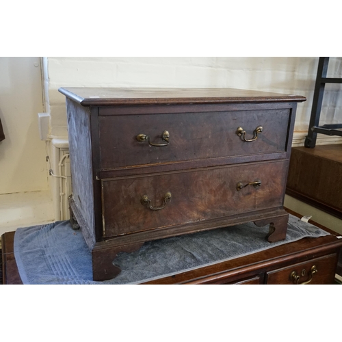 551 - An Oak Two Drawers Chest resting on bracket Feet. (AF). Measuring: 65cms across x 40cms deep x 47cms... 