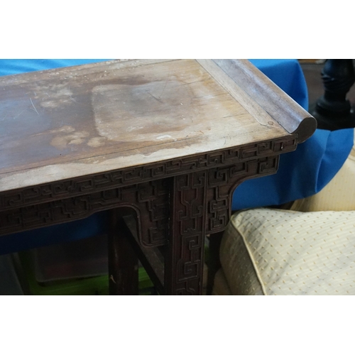 555 - A Japanese Hardwood Scroll Table with a Key Carved Bordered Front resting on Square Legs. Measuring:... 